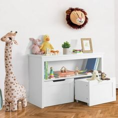 there is a stuffed giraffe and other toys on the shelf in this child's room