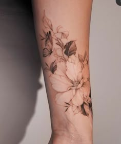 a woman's arm with flowers on it