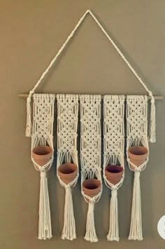 macrame wall hanging with plant pots and tassels