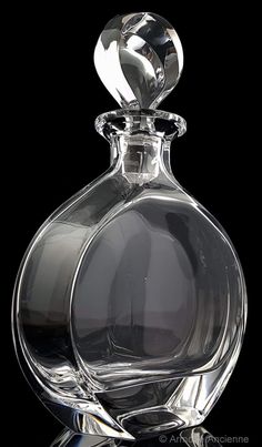 a clear glass bottle with a black background