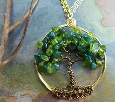 We handmade this unique & gorgeous wire wrapped Tree of Life pendant necklace. The pendant is made with Peridot & dark green Jade gemstones using gold craft wires for the outer ring, vintage bronze wires for the tree trunk & branches. The pendant measures between 1.60 to 1.70 inch in diameter. It comes with your choice of chain. Each pendant is handmade, so please allow slight variations from the shape of the branches and placement of the stones as shown. **Introducing NEW Deerskin L Jade Tree, Wire Wrapped Tree Of Life, Wire Wrapped Tree, August Birthstone, Dope Jewelry, Tree Of Life Necklace, Tree Of Life Pendant, August Birth Stone, Green Jade