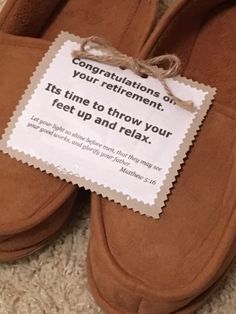 a pair of brown slippers with a sign stating congratulations on your retirement it's time to throw your feet up and relax