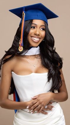 a woman in a graduation cap and gown posing for the camera with her hand on her hip