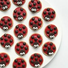 cookies decorated like ladybugs with googly eyes on a plate