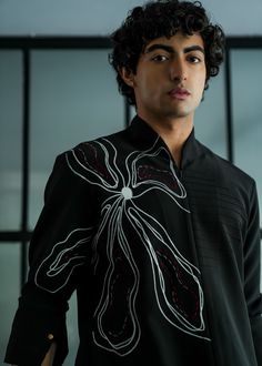 Featuring a black handpainted shirt kurta on a knit base with an abstract flower overlay with grey and wine thread details. Designer Black Shirt For Spring, Black Shirt With Floral Embroidery For Fall, Black Long Sleeve Kurta For Spring, Black Cotton Kurta For Spring, Fitted Black Spring Kurta, Mango Crepe, Jatin Malik, Flower Overlay, Paint Abstract