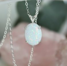 "Beautiful Large white lab-created opal pendant necklace. These gorgeous opals are very similar to natural mined opals. Lab-created opals contain 70-90% silica (from which natural opal is formed) and 10-30% resin. The resin makes the opal harder, stronger, unlike natural opals, which are known to be soft and fragile. Each opal displays a rainbow of color that sparkles with every catch of light. I've handset two different size opals in a solid sterling silver prong settings 16x12mm (5/8\" x 1/2\" White Ethiopian Opal Gemstone Jewelry, White Oval Opal Necklace, White Opal Round Pendant Necklace, White Opal Necklace For Gift, White Ethiopian Opal Gemstone Necklace, White Ethiopian Opal Cabochon Jewelry, White Opal Pendant Jewelry, White Opal Gemstone Necklace, White Opal Cabochon Necklaces