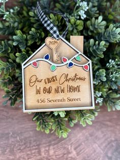 a wooden ornament with a key hanging from it's side on top of a tree