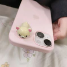 a cell phone case with a small animal on it's side and a camera attached to the back