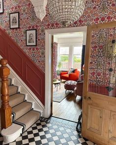 an entry way with stairs and pictures on the wall