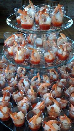 there are many small cups with shrimp in them