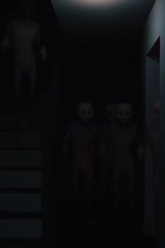 three creepy people standing in the dark next to stairs