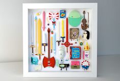 a shadow box filled with lots of different types of items in it's white frame