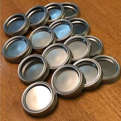 a pile of empty tins sitting on top of a wooden table