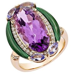 An oval-shaped amethyst stone with a checkerboard cut appears in the ring. On The top and bottom have studded tanzanite in marquise form on both sides, and the malachite stones in fancy cut on the side of the amethyst stone perfectly represent the ring's style. This ring is designed for those who wish to wear it to parties and special occasions. This ring embellished with diamonds is made of 18karat rose gold, which appears really fascinating and attractive. Amethyst Fancy Ring in 18Karat Rose Gold with Tanzanite, Malachite and White Diamond. Amethyst: 6.42 carat, 18X9mm size, oval shape. Tanzanite: 0.48 carat, 5X2.5mm size, marquise shape. Malachite: 1.70 carat, mix size, Fancy shape. White Diamonds: 0.19 carat, 1.20mm size, G color, VS clarity. White Diamonds: 0.01 carat, 1.00mm size, G Amethyst Cocktail Ring, Fancy Rings, Malachite Stone, Multi Stone, Amethyst Stone, White Diamonds, Cocktail Ring, Cocktail Rings, White Diamond