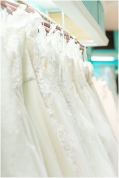 wedding gowns are on display in a store