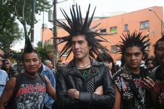 a group of young men standing next to each other in front of a crowd with their arms crossed