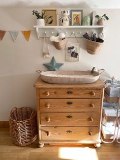 a baby's crib in the corner of a room next to a dresser