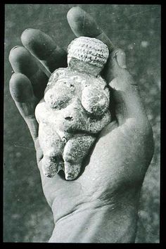 a black and white photo of a person holding some rocks