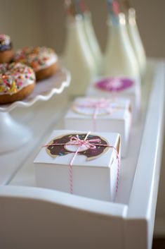 donuts and milk are on the table for guests to enjoy their snack time together