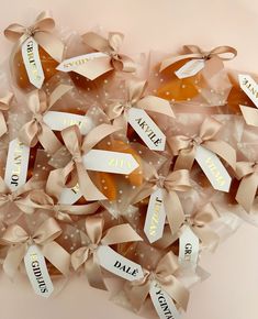 some cookies are wrapped in brown ribbon and have name tags on them that spell out date