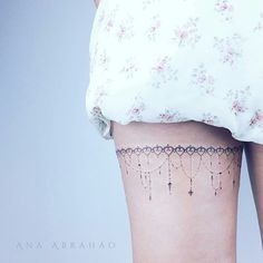 there is a tattoo on the back of a woman's thigh