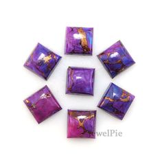 six purple and gold square beads on a white background