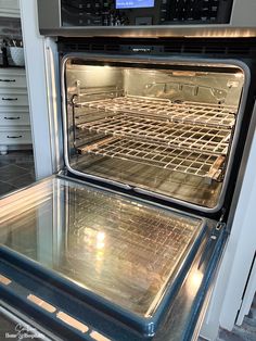 two open ovens side by side with the door open and light on, in a kitchen