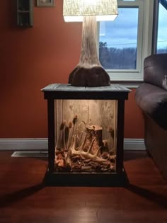 a lamp that is sitting on top of a table in front of a fire place