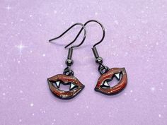 Goth vampire teeth earrings!  ✨Charms are zinc alloy with  ✨Earring hooks are gunmetal-tone hypoallergenic surgical 316L stainless steel and include clear silicone earring backs. ✨Clip-on option is available upon request! Please DM me before purchasing for more information.  Feel free to reach out if you have any questions! (: Teeth Earrings, Goth Vampire, Pride Earrings, Earrings Gothic, Vampire Teeth, Earrings Charms, Mini Envelopes, Seal Design, Earring Hooks