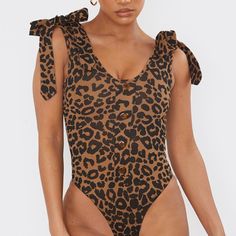 Animal Print Bodysuit With Tied On Top Never Worn Vacation V-neck Printed Bodysuit, White Mesh Bodysuit, Fitted V-neck Printed Bodysuit, Pink Lace Bodysuit, Printed V-neck Bodysuit For The Pool, Asymmetric Bodysuit, Purple Bodysuit, White Long Sleeve Bodysuit, High Cut Bodysuit