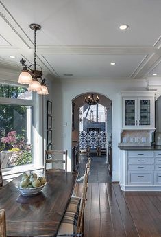 an open kitchen and dining room with wood flooring