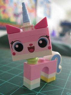 a pink lego toy with a unicorn on it's head sitting on top of a table