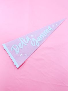 a pink pennant with the words deltagramma on it and stars in white lettering