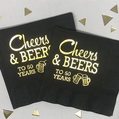 two black napkins with cheers and beers printed on them