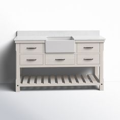 a white bathroom vanity with drawers and a sink