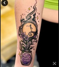 a woman's arm with a clock and flowers tattoo on the left side of her leg