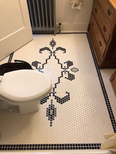 a white toilet sitting in a bathroom next to a radiator