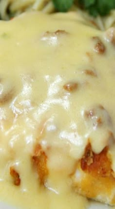 a close up of a plate of food with cheese and sauce on the top,