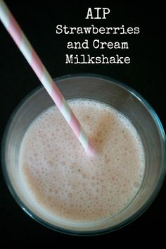 a glass filled with milk and topped with a pink and white striped straw next to the words aip strawberries and cream milkshake