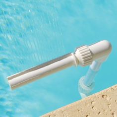 a close up view of a pool with a water sprinkler attached to it