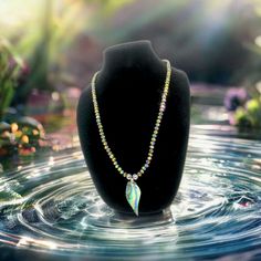 This stunning single-strand necklace featuring holographic crystals and an abalone pendant boasting iridescent sparkle will dazzle you. Length: 19.5 inches. It is eye-catching and transforms any outfit. A sacred symbol from the sea, Abalone is also believed to have healing properties. It is said to carry energies of protection and emotional balance. It is especially helpful for those going through emotional turmoil or those having a hard time dealing with a situation in a relationship Iridescent Crystal Jewelry With Rhinestones, Iridescent Crystal Pendant Necklace For Jewelry Making, Iridescent Crystal Pendant For Jewelry Making, Sacred Symbols, Crystal Pendant Necklace, Crystal Necklace Pendant, Nature Jewelry, Crystal Pendant, Wearable Art