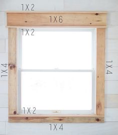 the measurements for a window frame are shown in front of a white wall with wood planks