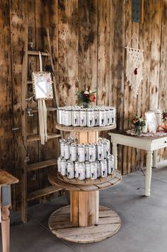 many jars are stacked on top of each other in a room with wooden walls and flooring