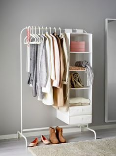 a white closet with clothes and shoes on it