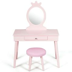 a pink dressing table with mirror and stool