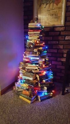 a christmas tree made out of books on the floor