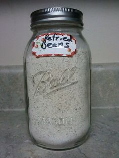 a glass jar filled with some kind of food on top of a counter next to a tile floor