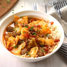 a white bowl filled with pasta and meat