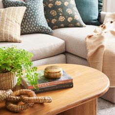 a living room with a couch, coffee table and books on the top of it