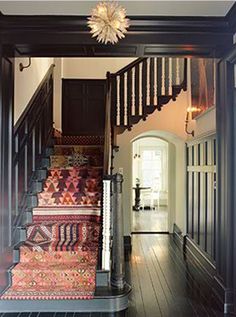 an instagram page with stairs and rugs on the floor in front of a door